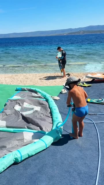 Preparing kites at the waterside school in Bol