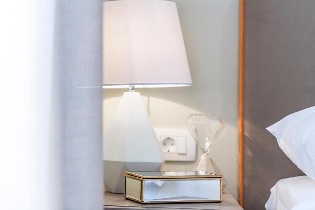Bedside lamp and table at Piano Nobile Rooms in Split
